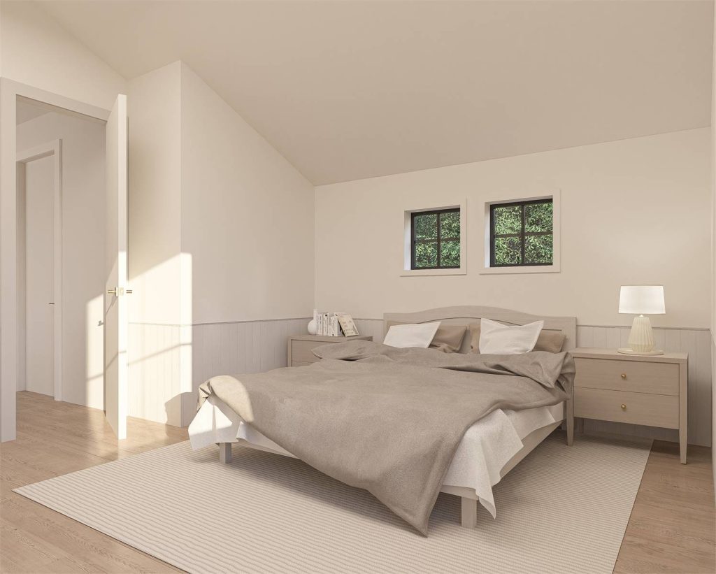 A spacious primary bedroom with windows and vaulted ceilings