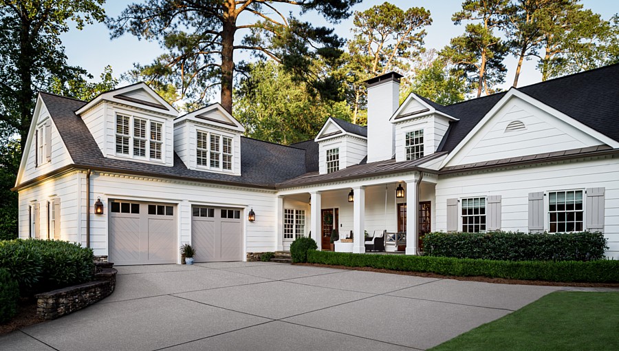 Beachy Colonial Home with Chevron Carriage House Garage Doors (Photo Credit: Andy Frame Photography)